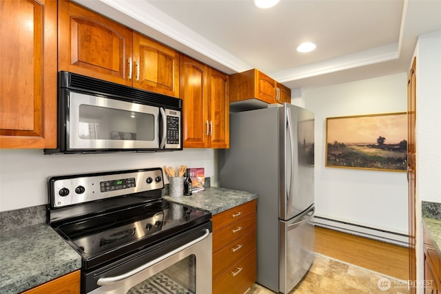 kitchen featuring a baseboard radiator, recessed lighting, stainless steel appliances, brown cabinets, and dark countertops