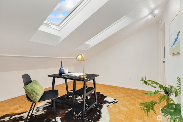 office with lofted ceiling with skylight and baseboards