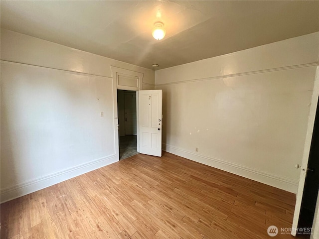 unfurnished bedroom featuring light wood-type flooring and baseboards