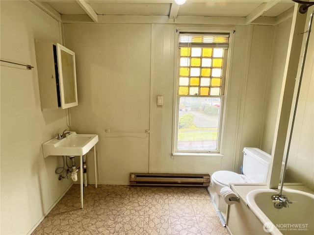 full bath featuring a sink, a baseboard radiator, a bathing tub, and toilet