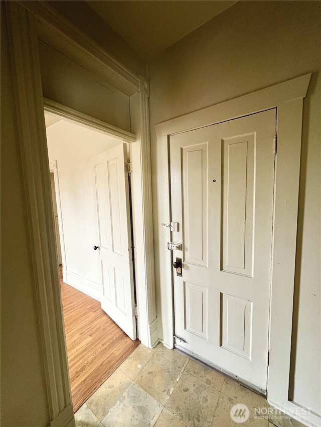 interior space with stone finish flooring and baseboards