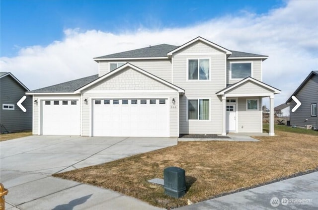 view of front facade with a front lawn, driveway, and an attached garage