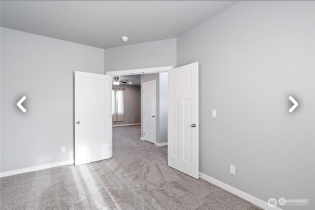 unfurnished bedroom featuring carpet flooring and baseboards