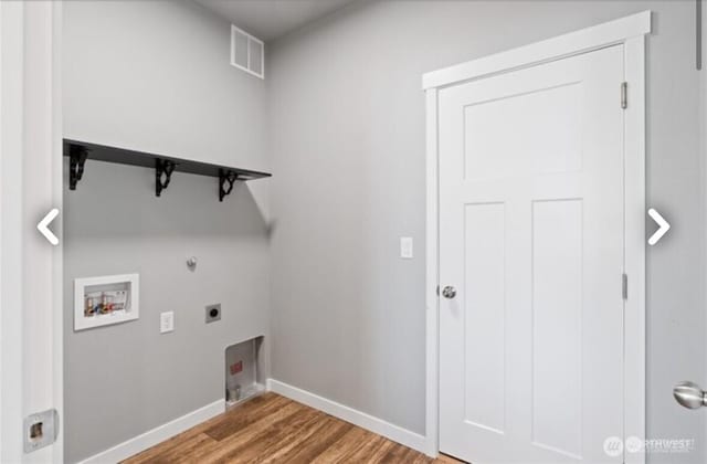 laundry area featuring laundry area, visible vents, wood finished floors, washer hookup, and electric dryer hookup