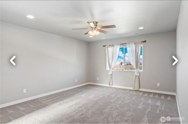 empty room featuring a ceiling fan, carpet, visible vents, and baseboards