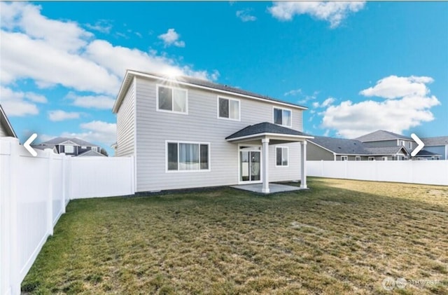 back of house with a patio, a lawn, and a fenced backyard