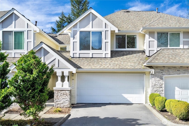 view of front of house with a shingled roof and stone siding