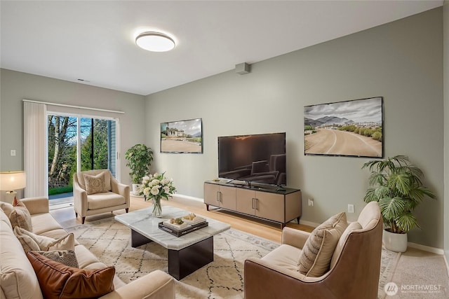 living room with baseboards and wood finished floors