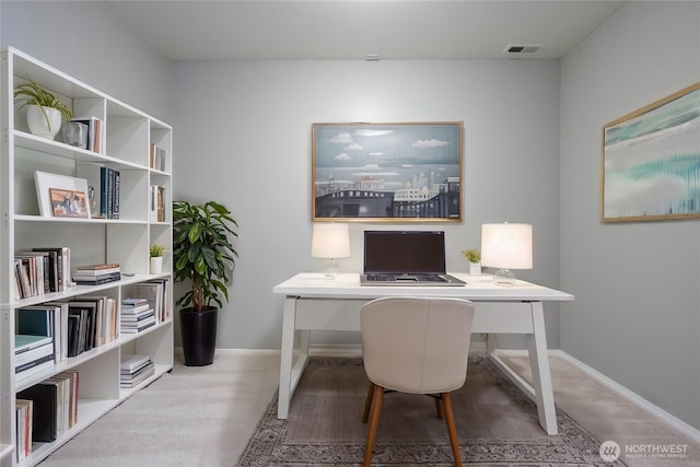 office area with visible vents and baseboards