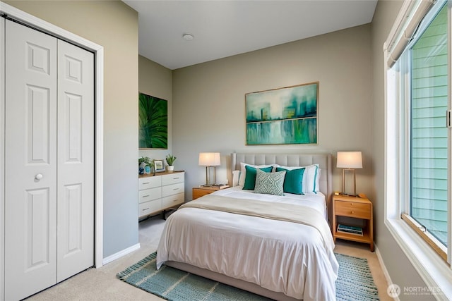 carpeted bedroom featuring multiple windows and baseboards