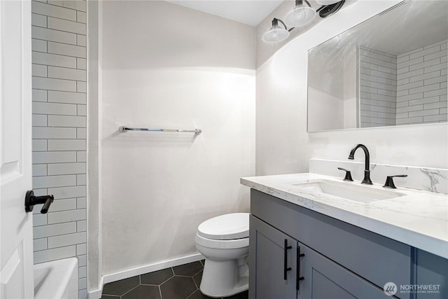 full bathroom featuring baseboards, vanity, toilet, and tile patterned floors