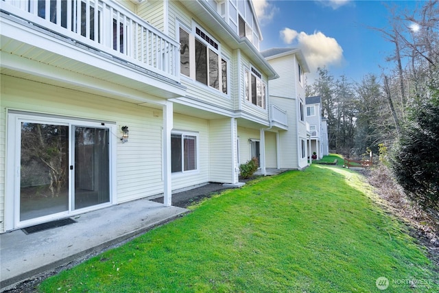 view of yard with a balcony