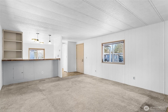 unfurnished living room with carpet and visible vents