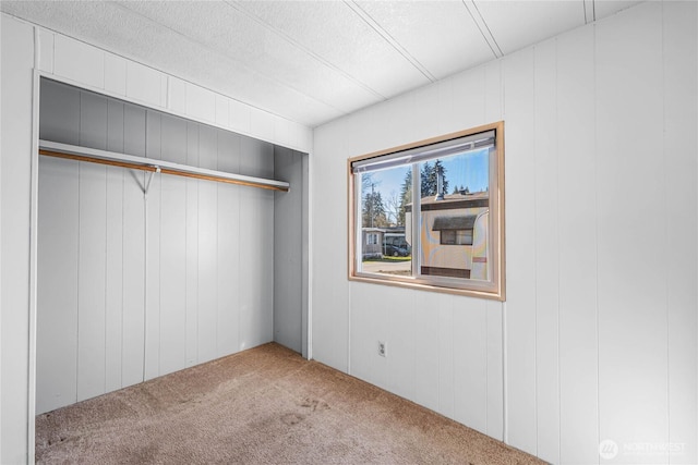 unfurnished bedroom with a closet and carpet flooring