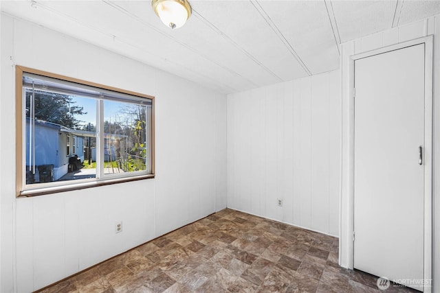 unfurnished room featuring stone finish floor