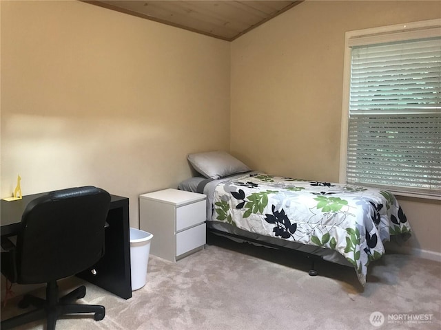 bedroom with light carpet and lofted ceiling