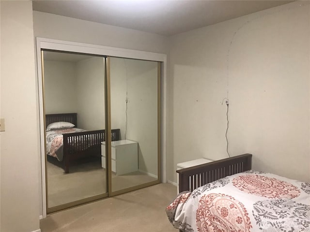 carpeted bedroom with a closet