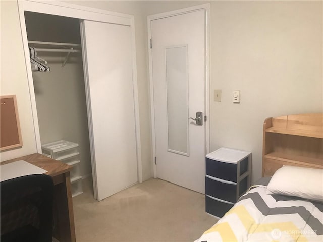 carpeted bedroom with a closet