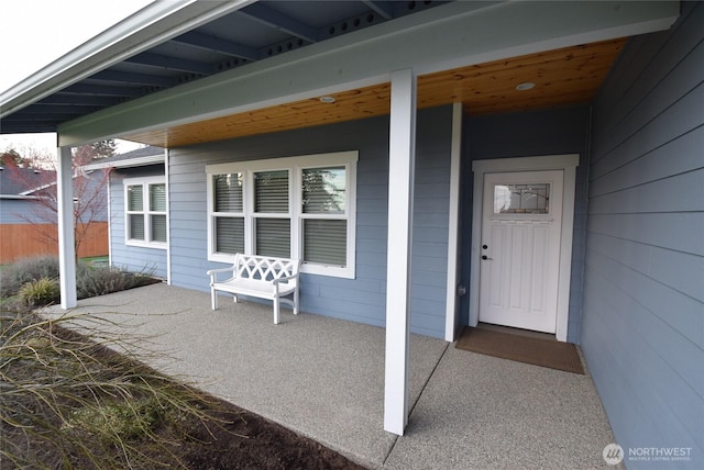 view of exterior entry with covered porch