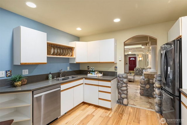 kitchen featuring dishwasher, freestanding refrigerator, white cabinetry, open shelves, and a sink