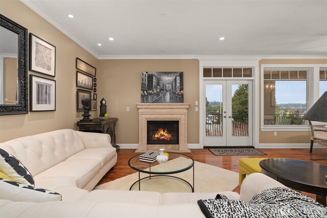 living room with a fireplace with flush hearth, ornamental molding, wood finished floors, french doors, and recessed lighting