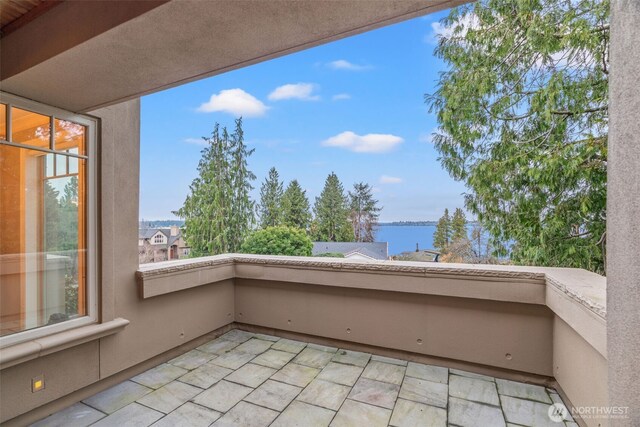 balcony featuring a water view