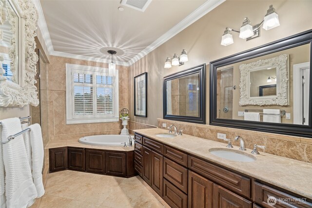 full bathroom featuring a garden tub, visible vents, ornamental molding, and a sink