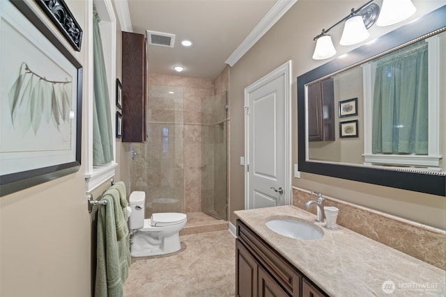 bathroom featuring toilet, visible vents, vanity, a shower stall, and crown molding