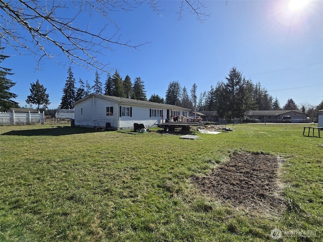 view of yard featuring fence and a wooden deck