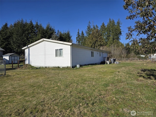 view of side of property with fence and a yard