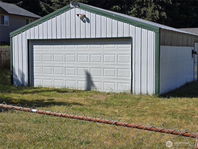 detached garage featuring fence