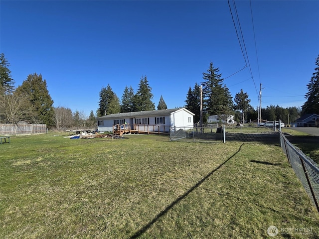 view of yard with a deck and fence