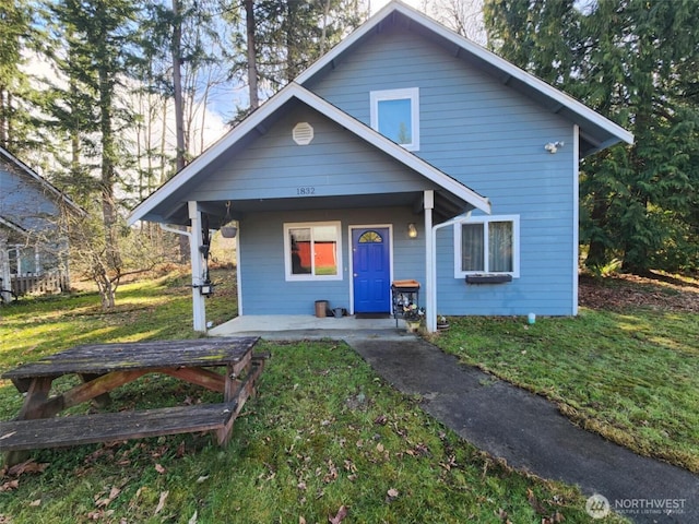 bungalow-style house with a front yard