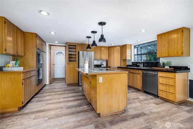 kitchen featuring light wood-style flooring, a kitchen island, appliances with stainless steel finishes, and recessed lighting