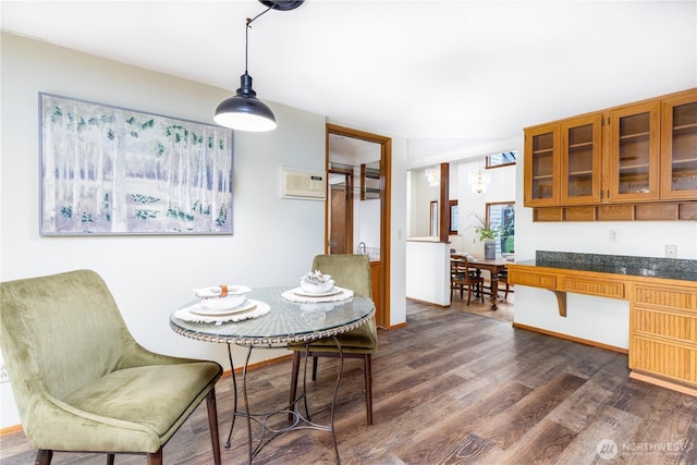 dining area with dark wood-style floors and baseboards