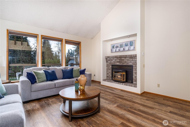 living area featuring high vaulted ceiling, a fireplace, baseboards, and wood finished floors