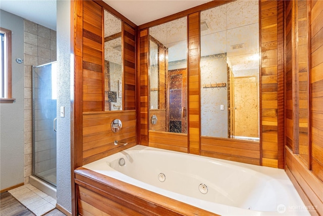 bathroom featuring a jetted tub, tile patterned flooring, and a stall shower