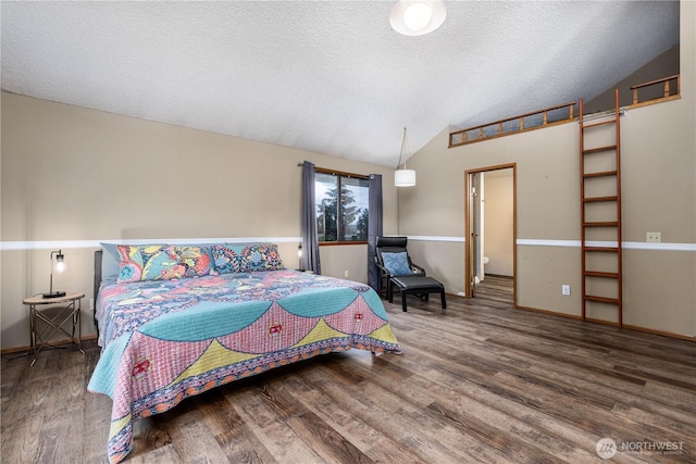 bedroom featuring a textured ceiling, baseboards, vaulted ceiling, and wood finished floors