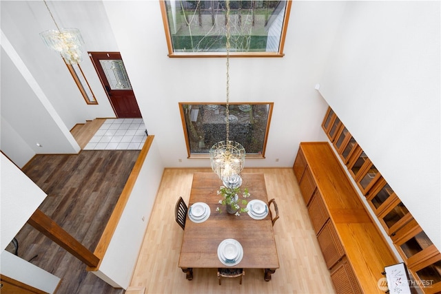 living area featuring wood finished floors and an inviting chandelier