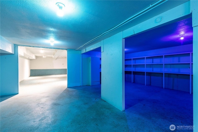 basement featuring a textured ceiling