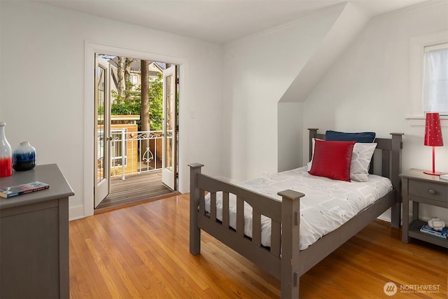 bedroom featuring access to exterior and light wood-style floors