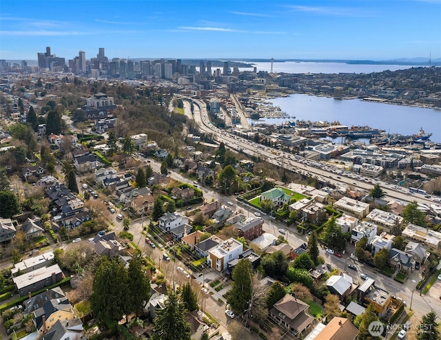 birds eye view of property with a view of city and a water view