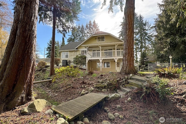 rear view of house featuring fence and cooling unit