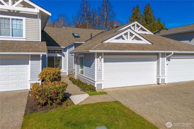 townhome / multi-family property featuring driveway and a shingled roof