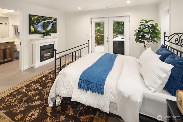 bedroom featuring access to exterior, visible vents, connected bathroom, recessed lighting, and a glass covered fireplace