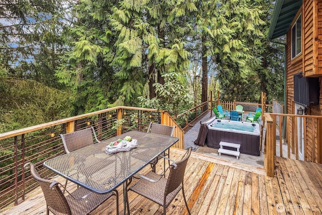 wooden deck with outdoor dining area and a hot tub