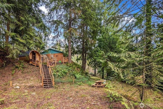 view of yard with stairway and a wooden deck