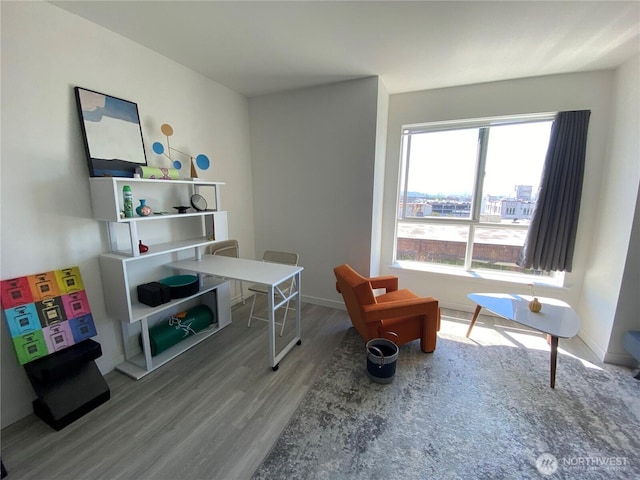 office area with baseboards and wood finished floors