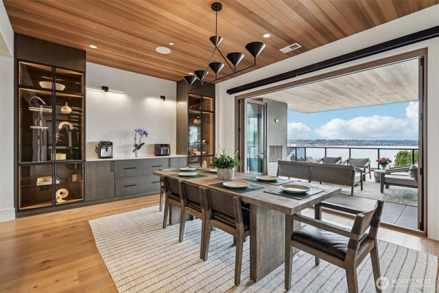 1658 10th St W, Kirkland, WA 98033 - dining space with light wood-style floors, wood ceiling, a water view, and recessed lighting