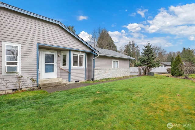 exterior space featuring crawl space and a lawn